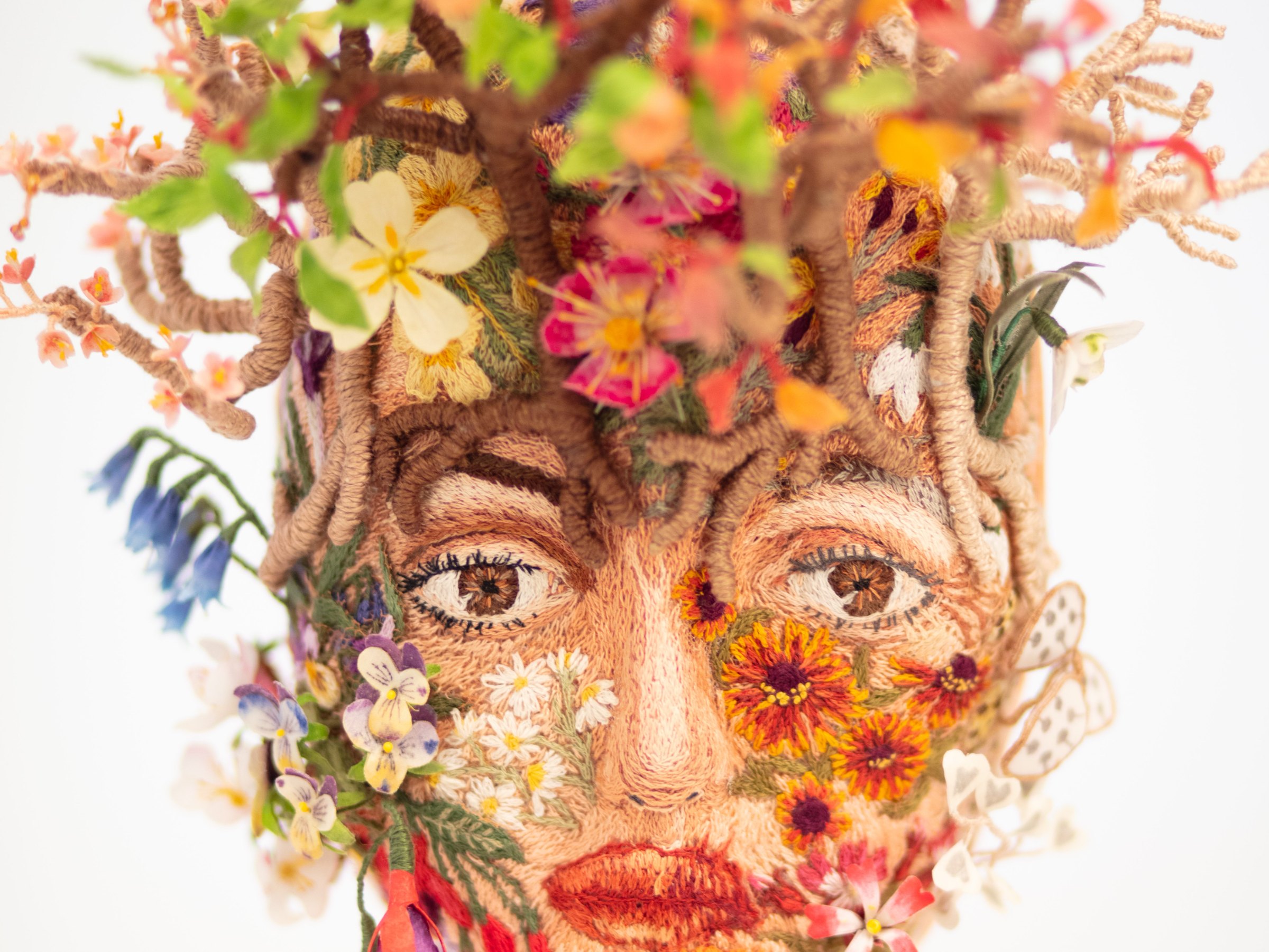 Needlepainted face and handmade silk flowers from My Metamorphosis